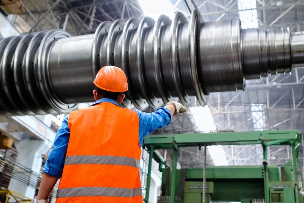 Back of an engineer pointing a large accelerator